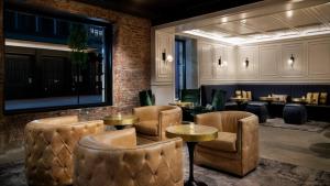 a restaurant with chairs and tables and a brick wall at Arthouse Hotel in New York
