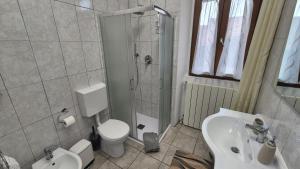 a bathroom with a shower and a toilet and a sink at Corte Malpensa in Somma Lombardo