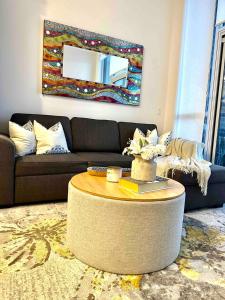 a living room with a couch and a table with a mirror at Friday Harbour Resort in Innisfil +45 photos