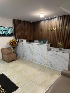 a lobby of a hotel with a reception desk at Hotel De La Prada in Maicao