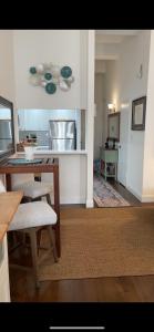 a living room with a table and a kitchen at Unique Place in midtown NYC in New York