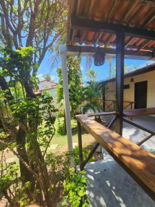a wooden bench in front of a house at Pipa Villa Mar in Pipa