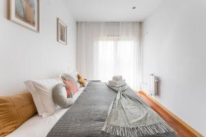 Una sala de estar con un sofá blanco y una ventana. en Family retreat in Gaia, en Vila Nova de Gaia
