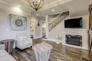 a living room with a fireplace and a tv at Modern Comfort Near Columbus Home with Yard and Porch in London