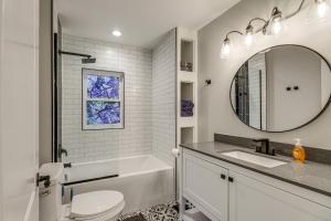 a bathroom with a sink and a toilet and a mirror at Modern Comfort Near Columbus Home with Yard and Porch in London +22 photos