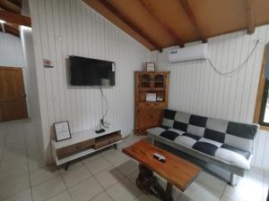 a living room with a couch and a table at Cabañas Mañio Melipeuco in Melipeuco