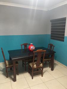 a dining room table with chairs and a vase on it at Departamento Familiar in Tampico +10 photos