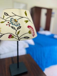 a lamp on a table with a flower pattern on it at La Gorgonia in Trapani