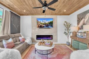a living room with a couch and a fireplace at Family Chalet With Rooftop Theater GameRoom Mins to DT in Gatlinburg +159 photos