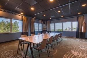 a conference room with a long table and chairs at Leonardo Hotel Vinkeveen Amsterdam in Vinkeveen +72 photos
