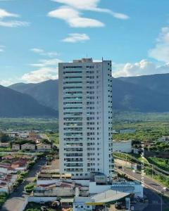 a tall white building in the middle of a city at Seller residence in Sobral