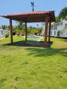 a gazebo in a yard with a pool at Confort House in Barrio Nuevo
