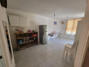 a kitchen with a refrigerator and a table in it at Confort House in Barrio Nuevo
