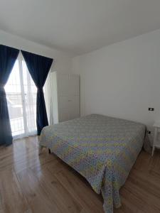a bedroom with a bed with blue drapes at Solleone - Appartamento 2B in Paestum +17 photos