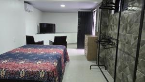 a bedroom with a bed in a room with a wall at Itacurubi Florianópolis in Florianópolis