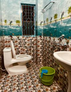 a bathroom with a toilet and a sink at Peaceful Retreat in Guwahati
