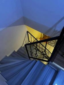 a blue staircase with a metal railing in a building at Green AirPort apart in Arnavutköy