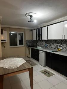 a kitchen with a table and a counter top at Green AirPort apart in Arnavutköy