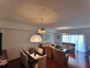 a living room with a couch and a table and chairs at Recanto da Tia in Póvoa de Santa Iria