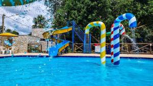 a swimming pool with a water park with slides at Pousada Vilhena in Vilhena