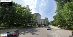 a street with cars parked on the side of a building at Cosy one bedroom apartment in Tomaszów Mazowiecki
