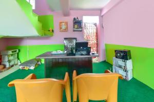 a room with two chairs and a desk with a computer at Hotel O Lucky Guest House in Khagaul