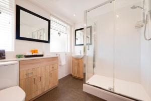 Un baño con ducha, bañera y lavabo. en Broadway Bungalow, en Heacham 15 fotos más
