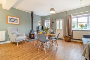a living room with a table and chairs and a couch at The Old Post Office in Bentley