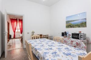 a bedroom with a bed and a table with a microwave at La Campidanese IUN R3640 in Càbras