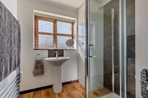 a bathroom with a sink and a shower at 1 Street Farm Cottages in Bodham +20 photos