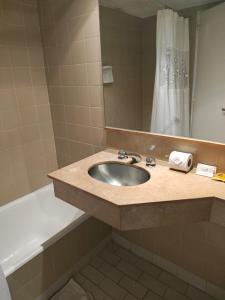 a bathroom with a sink and a tub and a mirror at Tango BA in Buenos Aires +9 photos