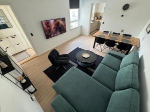 a living room with a green couch and a table at Sønderborg centrum in Sønderborg