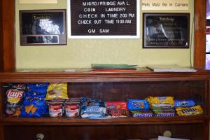 a shelf with chips and other snacks on it at Travelodge Inn & Suites by Wyndham Norman in Norman