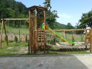 a playground with a slide in a park at Mini Complex Rilski Terasi in Sapareva Banya