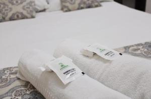 two beds with white towels on top of them at Pousada Brisa de Gramado in Gramado +19 photos