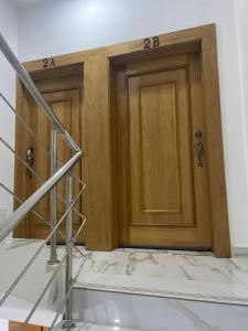 two wooden doors in a room with stairs at res Montesino in San Felipe de Puerto Plata +5 photos