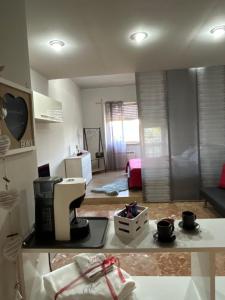 a kitchen and living room with a coffee maker on a counter at Marianna Guest House in Bracciano +45 photos
