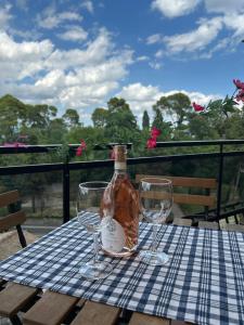 a bottle and two wine glasses sitting on a table at Marianna Guest House in Bracciano