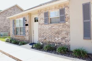a brick house with a white door and windows at Chic Townhome near LA Tech in Ruston