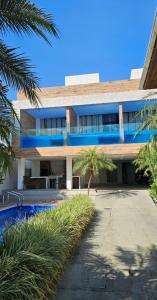 a building with a palm tree in front of it at Pousada Exclusive in Florianópolis