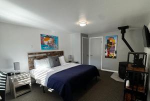 a bedroom with a bed and a television in it at R3 Hotel LGBTQIA All Welcome Adults Only in Guerneville