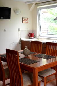 a kitchen with a table and chairs and a window at Apartament sopot 2 pokoje in Sopot