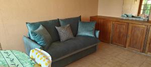 a blue couch with pillows in a living room at Bella Vista Colline Valmer in La Croix-Valmer