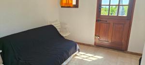 a bedroom with a bed and a wooden door at Bella Vista Colline Valmer in La Croix-Valmer