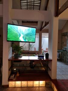 a large television on a wall in a room at Private Apt, AC, Jacuzzi, parking Centro in Escuintla