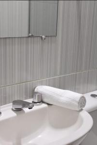 a bathroom with a white sink with a towel on it at Pousada Brisa de Gramado in Gramado