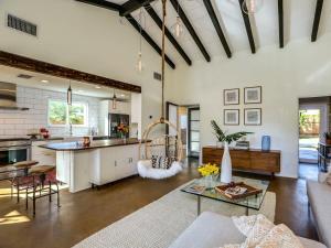 an open kitchen and living room with a table at Boho Rhapsody by ACME House Company in Palm Springs