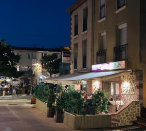 a restaurant on a city street at night at Détente au soleil in Sorède