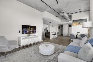 a living room with a couch and a tv at Tropicana Stadium 2 Bed In DWTWN With Free Parking in St Petersburg