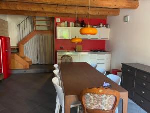 a kitchen with a dining room table and chairs at Da Luisa al Castello in Montemaggiore al Metauro